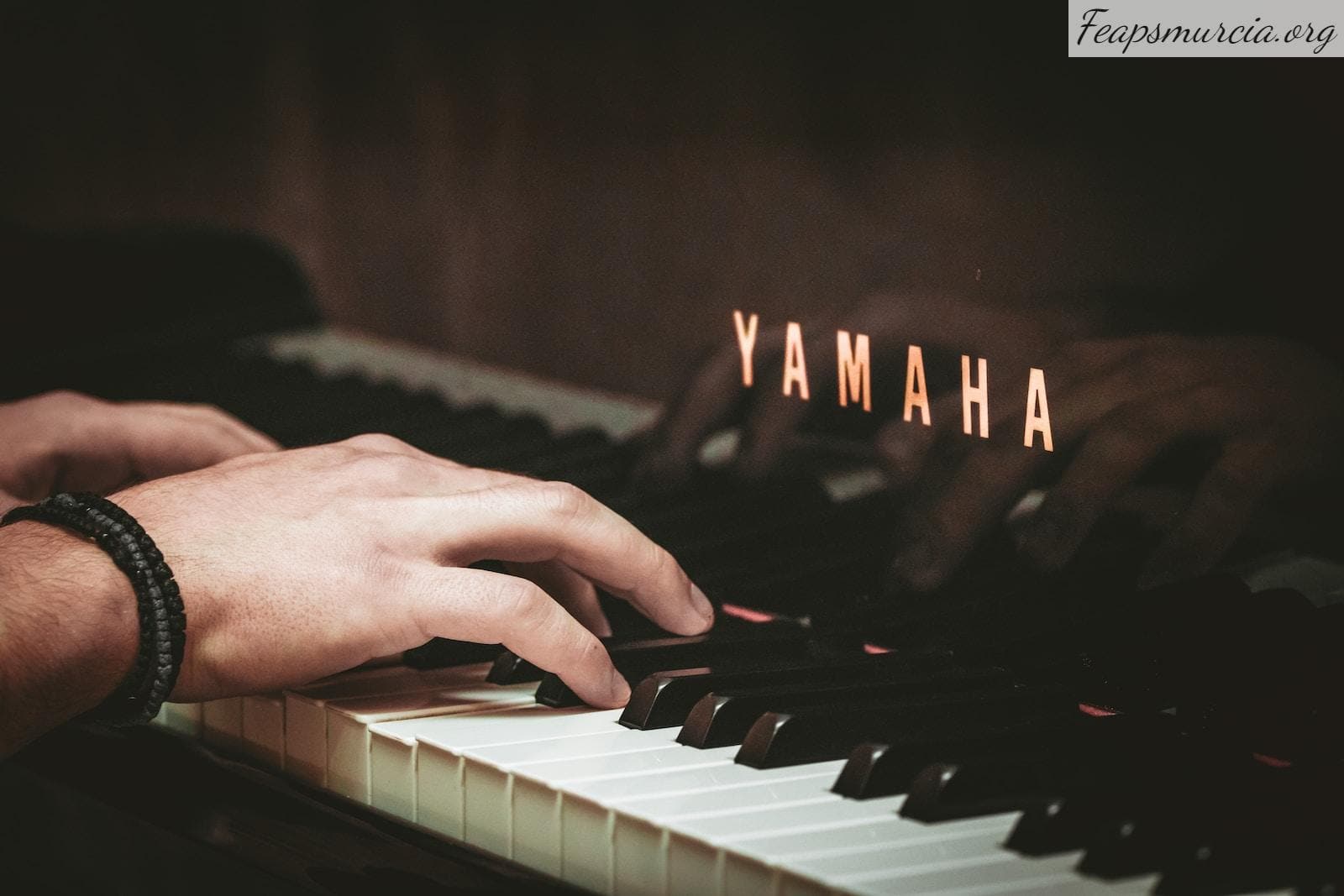 a close up of a person playing a piano